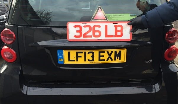 trade number plates on the back of a car